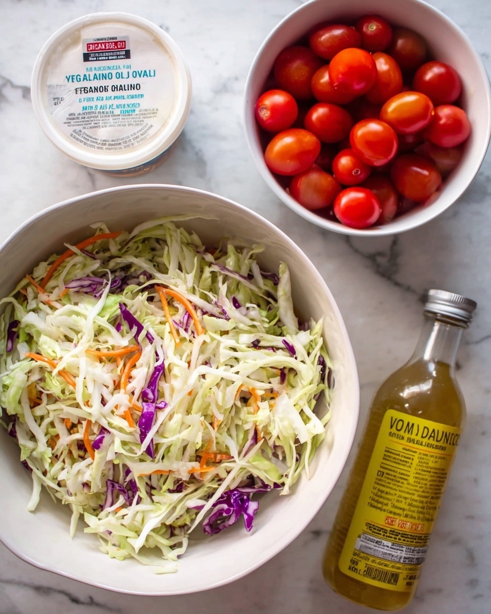 The image shows a white bowl filled with a shredded salad mix of thin layers of light green cabbage, pale white cabbage, some thin orange carrot strips, and a few pieces of purple cabbage scattered throughout. Next to the bowl is a white container of vegan mayo with avocado oil on a white marbled surface, along with a glass bottle of organic apple cider vinegar with a yellow label. There is also a smaller white bowl filled with bright red grape tomatoes. The whole scene is set on a white marbled surface, with all items arranged close together. Photo taken with an iphone --ar 4:5 --v 7