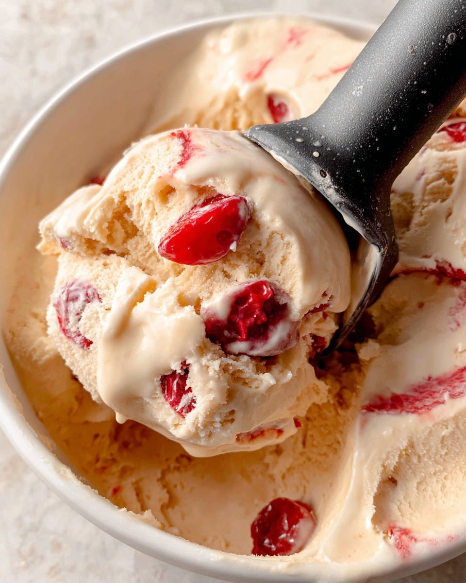 Two ice cream cones are shown in a close-up view, each cone filled with creamy ice cream that has swirls of red cherry sauce throughout. The ice cream is pale beige with smooth and slightly melting texture, visible drip on one cone. One cone has a bright red cherry with a long thin stem placed on top as a garnish. Both cones are light brown with a classic waffle pattern and are held upright in a small metal holder. The background is softly blurred with a white marbled texture surface underneath. photo taken with an iphone --ar 4:5 --v 7