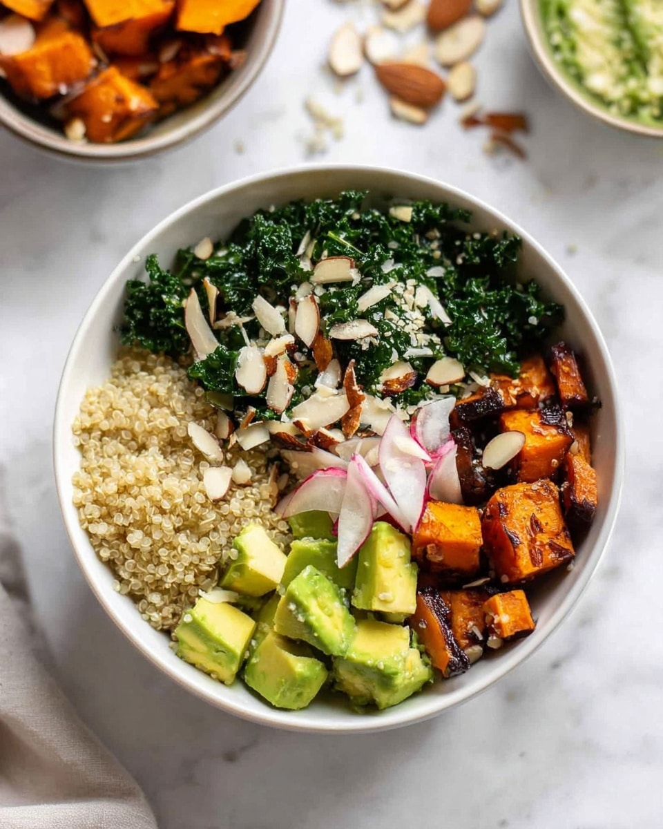 A white bowl sits on a white marbled surface, filled with four distinct layers arranged side by side. One quarter has light fluffy quinoa with a slightly grainy texture, another quarter holds dark green finely chopped kale with a leafy texture, the third quarter contains charred orange sweet potato chunks with a slightly blackened surface, and the last quarter has pale green avocado cubes topped with thin white and pink radish slices. The entire bowl is sprinkled with small chunks of chopped almonds for a crunchy texture. In the background, a small bowl with more roasted sweet potato pieces and some scattered almonds are visible. Photo taken with an iphone --ar 4:5 --v 7
